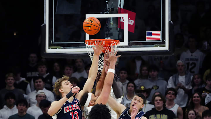 Mar 7, 2026; Boulder, Colorado, USA; Colorado Buffaloes center Elijah Malone (50), Arizona Wildcats center Motiejus Krivas (13) and forward Ivan Kharchenkov (8) reach for the ball in the first half at the CU Events Center. Mandatory Credit: Ron Chenoy-Imagn Images