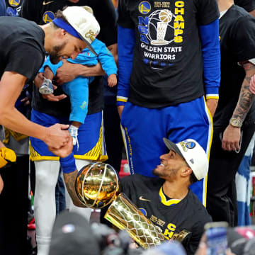Jun 16, 2022; Boston, Massachusetts, USA; Golden State Warriors guard Gary Payton II (0) holds the the Larry O'Brien Championship Trophy and celebrates with guard Klay Thompson (11) after the Golden State Warriors beat the Boston Celtics in game six of the 2022 NBA Finals to win the NBA Championship at TD Garden. Mandatory Credit: Kyle Terada-USA TODAY Sports