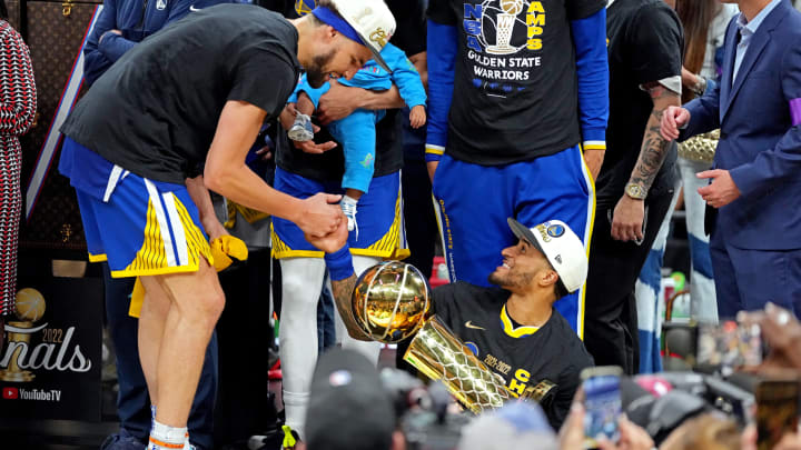 Jun 16, 2022; Boston, Massachusetts, USA; Golden State Warriors guard Gary Payton II (0) holds the the Larry O'Brien Championship Trophy and celebrates with guard Klay Thompson (11) after the Golden State Warriors beat the Boston Celtics in game six of the 2022 NBA Finals to win the NBA Championship at TD Garden. Mandatory Credit: Kyle Terada-USA TODAY Sports