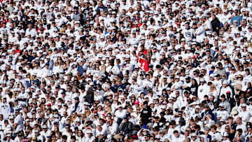 A lone Ohio State Buckeyes fan cheers in a sea of Penn State Nittany Lions fans