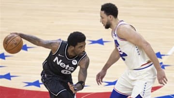 Kyrie Irving protects the basketball from Ben Simmons