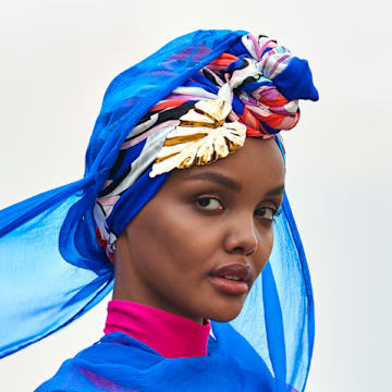 Halima Aden was photographed by Yu Tsai in Kenya. Burkini by Cover Swim. Barrette by LELET NY.