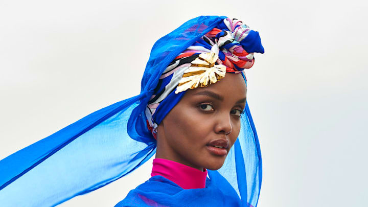 Halima Aden was photographed by Yu Tsai in Kenya. Burkini by Cover Swim. Barrette by LELET NY. Halima Aden was photographed by Yu Tsai in Kenya. Burkini by Cover Swim. Barrette by LELET NY.