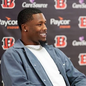 Ja’marr Chase reacts to Tee Higgins saying he plans to send his new money on an aquarium built into the wall of his home during a press conference to announce the signing of new contracts for Cincinnati Bengals wide receivers Ja’Marr Chase and Tee Higgins at Paycor Stadium in downtown Cincinnati on Tuesday, March 18, 2025. Chase becomes the new highest-paid non-quarterback player in the NFL.