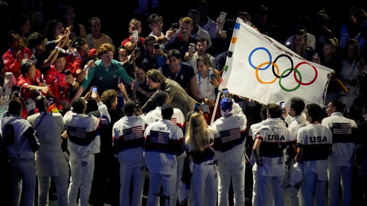 Aug 11, 2024; Saint-Denis, France; Tom Cruise rides a motorcycle carrying the Olympic flag during the closing ceremony for the Paris 2024 Olympic Summer Games at Stade de France.