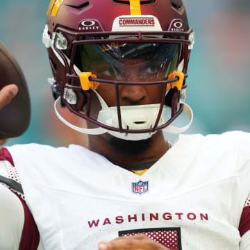 Aug 17, 2024; Miami Gardens, Florida, USA;  Washington Commanders quarterback Jayden Daniels (5) warms up before the preseason game against the Miami Dolphins at Hard Rock Stadium. Mandatory Credit: Jim Rassol-USA TODAY Sports