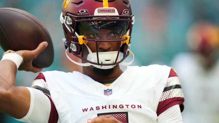 Aug 17, 2024; Miami Gardens, Florida, USA;  Washington Commanders quarterback Jayden Daniels (5) warms up before the preseason game against the Miami Dolphins at Hard Rock Stadium. Mandatory Credit: Jim Rassol-USA TODAY Sports