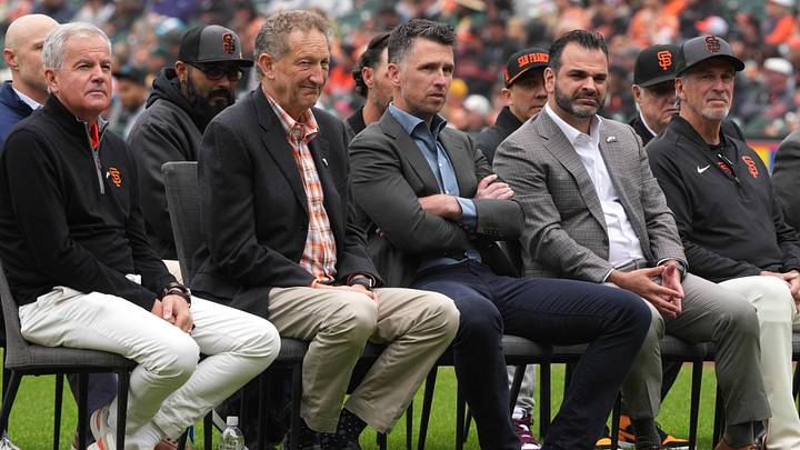 Apr 25, 2026; San Francisco, California, USA; (L to R) San Francisco Giants chairman Greg Johnson and president Larry Baer and president of baseball operations Buster Posey and general manager Zack Minasian sit on the field before the game against the Miami Marlins at Oracle Park. Mandatory Credit: Darren Yamashita-Imagn Images