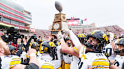 Nov 28, 2025; Lincoln, Nebraska, USA; The Iowa Hawkeyes hoist the Heroes Trophy after defeating the Nebraska Cornhuskers at Memorial Stadium. Mandatory Credit: Dylan Widger-Imagn Images