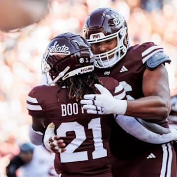 Mississippi State Running Back Davon Booth (#21) and Mississippi State Offensive Lineman Albert Reese IV (#76) during the game between the Arkansas Razorbacks and the Mississippi State Bulldogs at Davis Wade Stadium at Scott Field in Starkville, MS.
