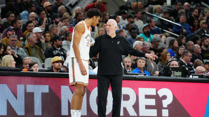 Mar 19, 2024; San Antonio, Texas, USA;  San Antonio Spurs forward Dominick Barlow (26) talks with head coach Gregg Popovich in the first half against the Dallas Mavericks at Frost Bank Center. Mandatory Credit: Daniel Dunn-USA TODAY Sports