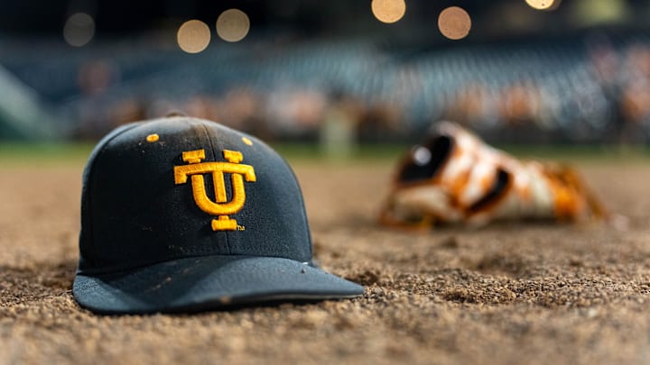 Jun 24, 2024; Omaha, NE, USA; A Tennessee Volunteers hat and glove lay on the field after defeating the Texas A&M Aggies in the championship at Charles Schwab Field Omaha. Mandatory Credit: Dylan Widger-Imagn Images