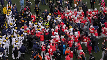 Players scrum at midfield following Saturday’s NCAA Division I football game between the Ohio State Buckeyes and the Michigan Wolverines.