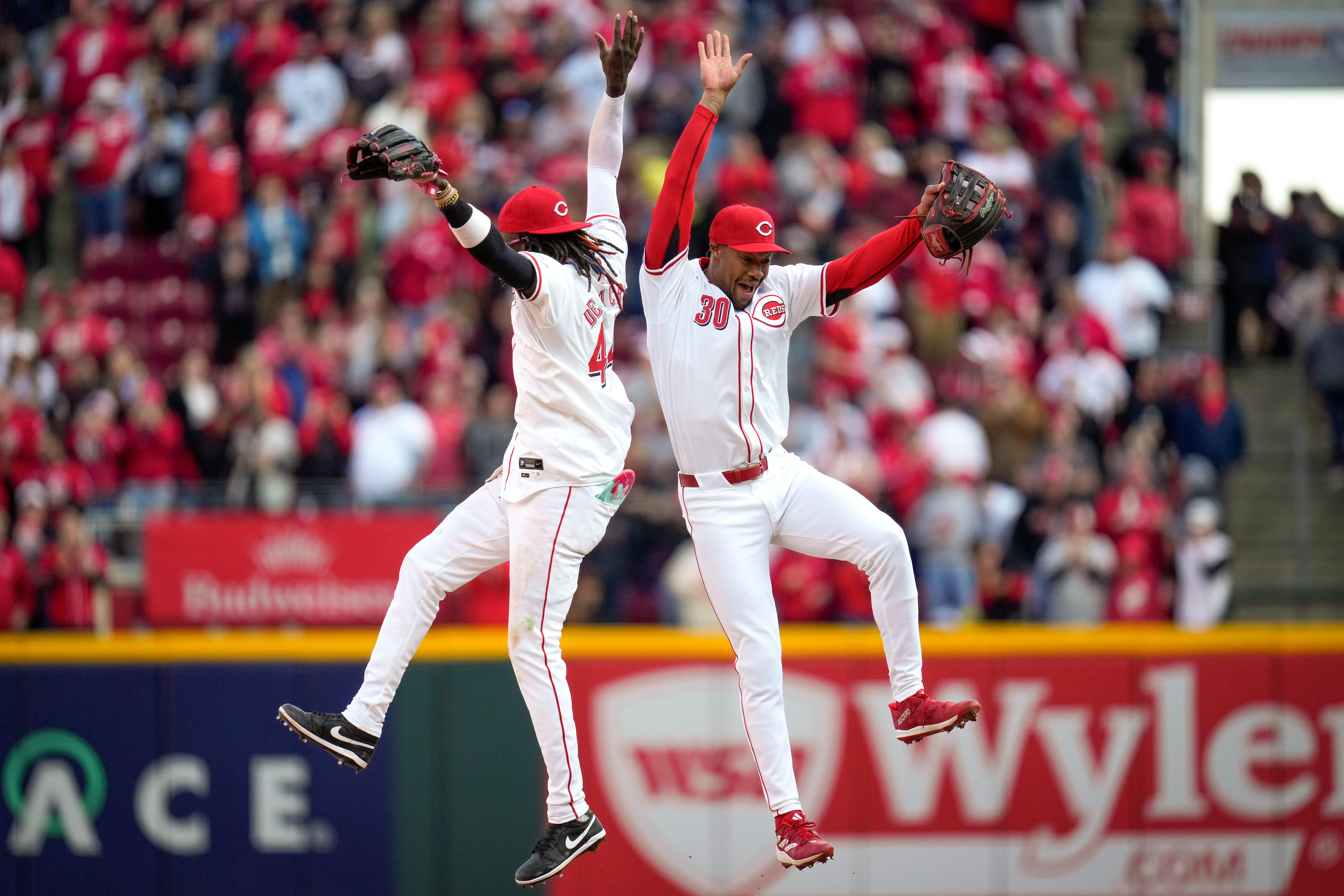 Cincinnati Reds shortstop Elly De La Cruz and center fielder Will Benson celebrate after a game.
