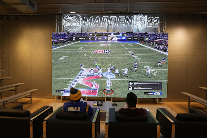 People play EA Sports Madden NFL video game at the Nike store at the Grove. 