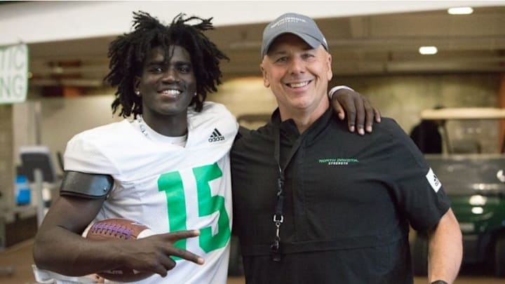 Etienne Higgins, a senior at Council Bluffs Lincoln, committed to North Dakota and head coach Bubba Schweigert, who is shown in this picture with him. 