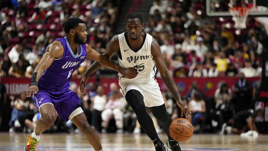 Jul 14, 2025; Las Vegas, NV, USA; San Antonio Spurs forward David Jones-Garcia (25) dribbles the ball against Utah Jazz guard Elijah Harkless (16) during the second half of a NBA basketball game at the Thomas & Mack Center. Mandatory Credit: Lucas Peltier-Imagn Images