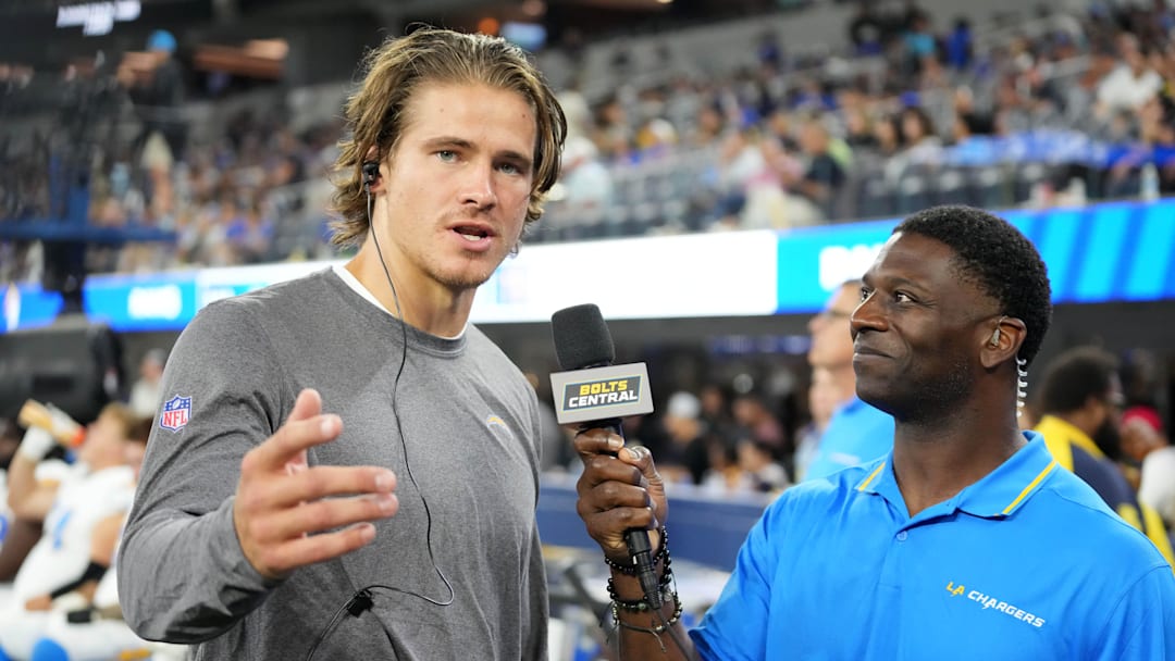 Aug 12, 2023; Inglewood, California, USA; Los Angeles Chargers quarterback Justin Herbert (left) is interviewed by LaDainian Tomlinson during the game against the Los Angeles Rams at SoFi Stadium. Mandatory Credit: Kirby Lee-Imagn Images
