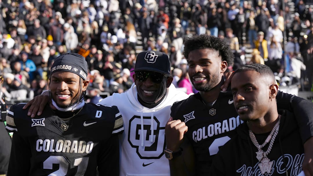 Nov 29, 2024; Boulder, Colorado, USA; Colorado Buffaloes safety Shilo Sanders (21) and head coach Deion Sanders and quarterback Shedeur Sanders (2) and social media producer Deion Sanders Jr. following the win against the Oklahoma State Cowboys at Folsom Field. Mandatory Credit: Ron Chenoy-Imagn Images