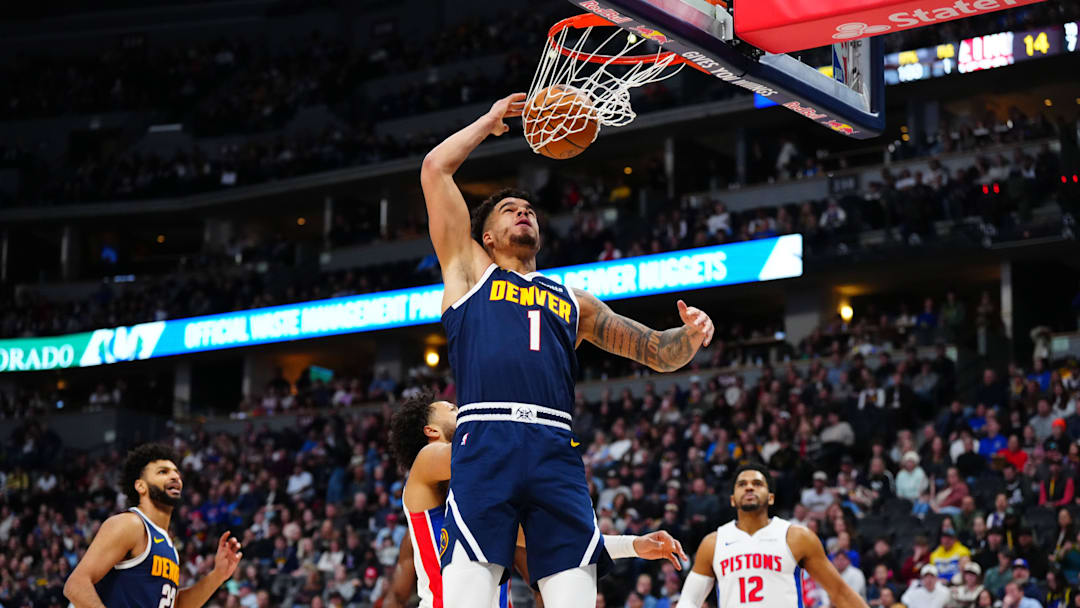 Dec 28, 2024; Denver, Colorado, USA; Denver Nuggets forward Michael Porter Jr. (1) finishes off a basket in the first quarter against the Detroit Pistons at Ball Arena. Mandatory Credit: Ron Chenoy-Imagn Images