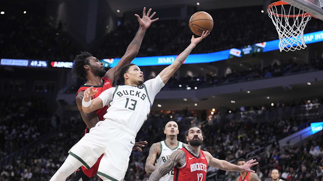 Nov 9, 2025; Milwaukee, Wisconsin, USA; Milwaukee Bucks guard Ryan Rollins (13) lays up a shot against Houston Rockets forward Tari Eason (17) in the second half at Fiserv Forum. Mandatory Credit: Michael McLoone-Imagn Images