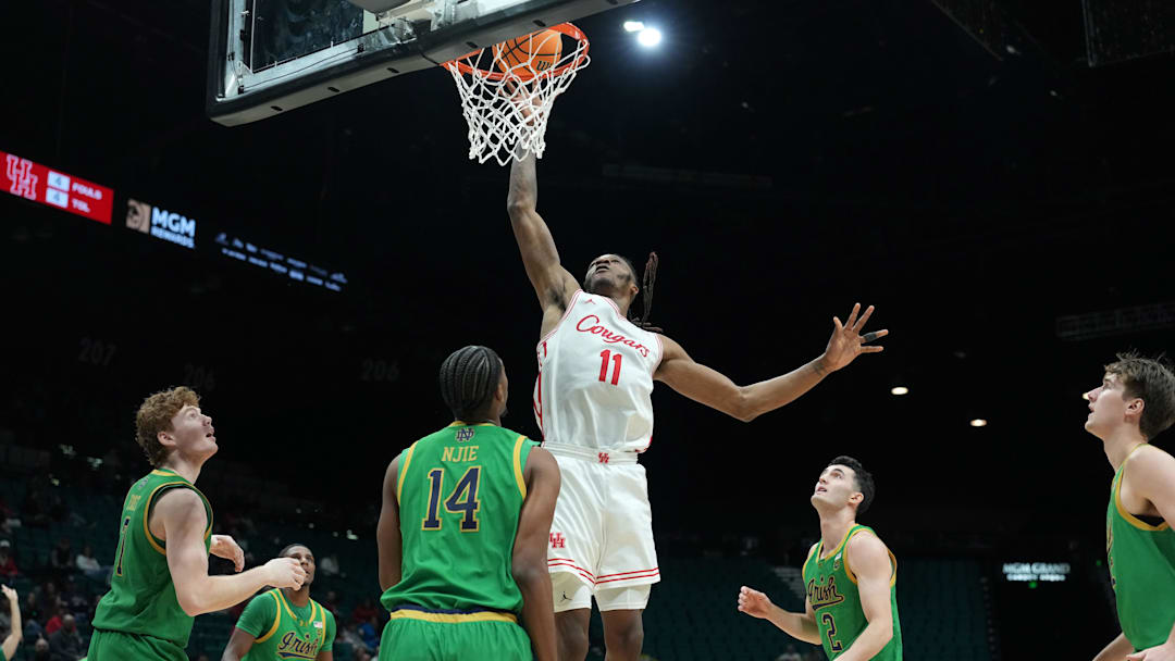 Nov 26, 2025; Las Vegas, NV, USA; Houston Cougars forward Joseph Tugler (11) shoots the ball against Notre Dame Fighting Irish forward Kebba Njie (14) in the 2025 Players Era Festival at MGM Grand Garden Arena. Mandatory Credit: Kirby Lee-Imagn Images