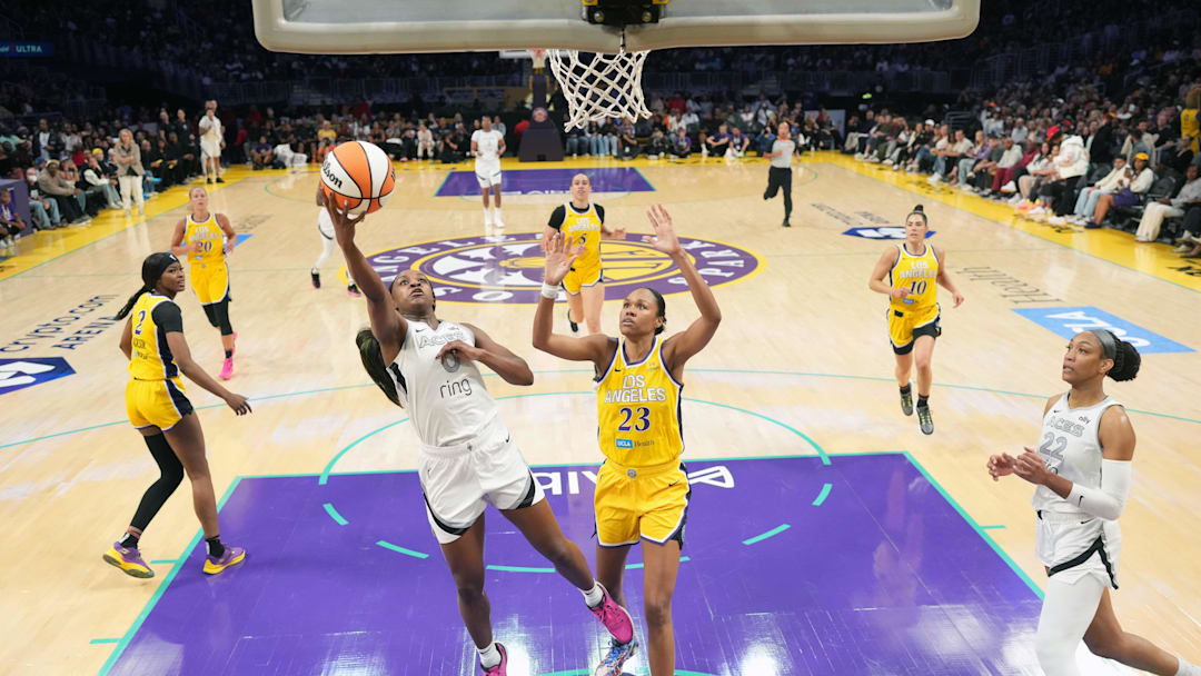 Jul 29, 2025; Los Angeles, California, USA; Las Vegas Aces guard Jackie Young (0) shoots the ball against LA Sparks forward Azura Stevens (23) in the first half at Crypto.com Arena. Mandatory Credit: Kirby Lee-Imagn Images