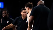 Cincinnati Bearcats guard Connor Hickman (8) listens to instructions from UC head coach Wes Miller in the Wednesday, Nov. 27 win over Alabama State.