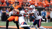Sep 8, 2024; Cincinnati, Ohio, USA; Cincinnati Bengals tight end Mike Gesicki (88) is tackled by New England Patriots corner back Marcus Jones (25) and New England Patriots linebacker Ja'Whaun Bentley (8) in the first quarter at Paycor Stadium. Mandatory Credit: Albert Cesare/USA TODAY Network via Imagn Images