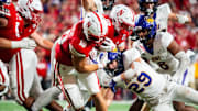 Sep 14, 2024; Lincoln, Nebraska, USA; Nebraska Cornhuskers quarterback Heinrich Haarberg (10) runs against Northern Iowa Panthers linebacker Tucker Langenberg (29) during the third quarter at Memorial Stadium.