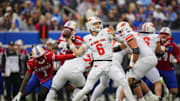 Nov 1, 2025; Lawrence, Kansas, USA; Oklahoma State Cowboys quarterback Zane Flores (6) throws a pass during the first half against the Kansas Jayhawks at David Booth Kansas Memorial Stadium. Mandatory Credit: Jay Biggerstaff-Imagn Images