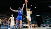 Nov 26, 2025; Las Vegas, NV, USA; Tennessee Volunteers guard Ja’Kobi Gillespie (0) shoots while Kansas Jayhawks guard Tre White (3) defends in the first half in the 2025 Players Era Festival third place game at MGM Grand Garden Arena. Mandatory Credit: Kirby Lee-Imagn Images