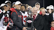 Western Kentucky Hilltoppers head coach Tyson Helton holds the trophy 