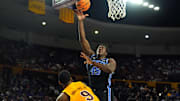 Feb 26, 2025; Tempe, Arizona, USA; Brigham Young Cougars center Fousseyni Traore (45) shoots over Arizona State Sun Devils center Shawn Phillips Jr. (9) at Desert Financial Arena. Mandatory Credit: Joe Camporeale-Imagn Images