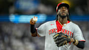 Cincinnati Reds shortstop Elly De La Cruz (44) throws a ball into the crowd after the second inning of the MLB National League Wild Card Game 2 between the Los Angeles Dodgers and the Cincinnati Reds at Dodger Stadium in Los Angeles on Wednesday, Oct. 1, 2025. The Reds were eliminated from the postseason with an 8-4 loss to the reining World Series Champions La Dodgers.