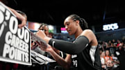 Jun 25, 2025; Las Vegas, Nevada, USA; Las Vegas Aces center A'ja Wilson (22) signs autographs for fans after an WNBA basketball game against the Connecticut Sun at Michelob Ultra Arena. 