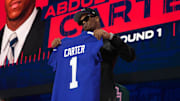 Abdul Carter poses with a Giants jersey after being picked in the 2025 NFL draft.