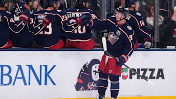 Blue Jackets forward Kent Johnson celebrates a goal with the bench.