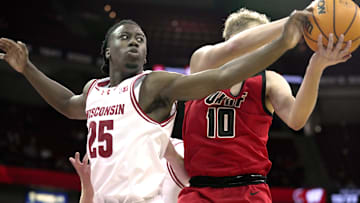 Wisconsin guard John Blackwell (25) tries to swat the all away from UW-River Falls guard Gavin Ralph (10) during the first half of their preseason game Wednesday, October 30, 2024 at the Kohl Center in Madison, Wisconsin.