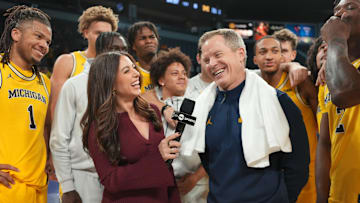 Nov 25, 2025; Las Vegas, NV, USA; TNT Sports reporter Lauren Jbara (left) interviews Michigan Wolverines head coach Dusty May after a 2025 Players Era Festival group play game against the Auburn Tigers at Michelob ULTRA Arena. Mandatory Credit: Kirby Lee-Imagn Images