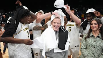 Nov 26, 2025; Las Vegas, NV, USA; Players celebrates with Michigan Wolverines head coach Dusty May after defeating the Gonzaga Bulldogs in the 2025 Players Era Festival championship game at MGM Grand Garden Arena. Mandatory Credit: Kirby Lee-Imagn Images