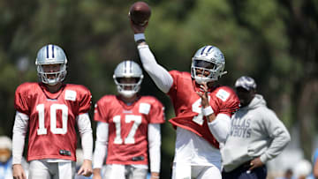 Aug 18, 2022; Costa Mesa, CA, USA; Dallas Cowboys quarterback Dak Prescott (4) throws the ball as quarterbacks Cooper Rush (10) and Ben DiNucci (17) watch during joint practice against the Los Angeles Chargers at Jack Hammett Sports Complex. Mandatory Credit: Kirby Lee-Imagn Images