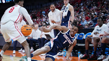 Mar 22, 2025; Wichita, KS, USA; Gonzaga Bulldogs guard Michael Ajayi (1) dives to keep the ball in play against Houston Cougars guard Mylik Wilson (8) during the first half at Intrust Bank Arena. Mandatory Credit: Kirby Lee-Imagn Images