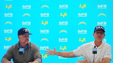Jan 15, 2025; El Segundo, CA, USA; Los Angeles Chargers general manager Joe Hortiz (left) and coach Jim Harbaugh at a press conference at The Bolt. Mandatory Credit: Kirby Lee-Imagn Images