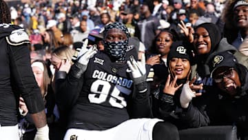 Nov 29, 2024; Boulder, Colorado, USA; Colorado Buffaloes defensive tackle Tawfiq Thomas (95) celebrates the win with fans following the game against the Oklahoma State Cowboys at Folsom Field. Mandatory Credit: Ron Chenoy-Imagn Images