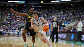 Mar 23, 2025; Raleigh, NC, USA; Duke Blue Devils guard Kon Knueppel (7) drives to the basket as Baylor Bears guard Jeremy Roach (3) defends during the first half in the second round of the NCAA Tournament at Lenovo Center. Mandatory Credit: Bob Donnan-Imagn Images