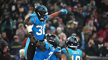 Nov 10, 2024; Munich, Germany; Carolina Panthers running back Chuba Hubbard (30) celebrates with offensive tackle Taylor Moton (72) and wide receiver Jalen Coker (18) after scoring on a 1-yard touchdown run against the New York Giants in the second half during the 2024 NFL Munich Game at Allianz Arena. Mandatory Credit: Kirby Lee-Imagn Images