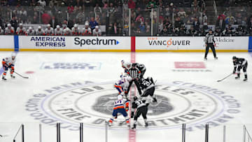Mar 11, 2025; Los Angeles, California, USA; A general overall view as NHL referee  Eric Furlatt (27), drops the puck on the opening faceoff between New York Islanders center Jean-Gabriel Pageau (44) and LA Kings center Phillip Danault (24) on the Los Angeles Fire Dept. logo at center ice at the Crypto.com Arena. Mandatory Credit: Kirby Lee-Imagn Images
