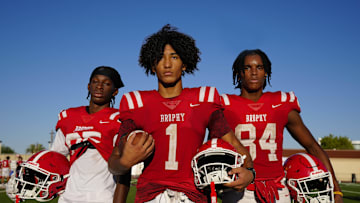 Brophy Prep wide receivers Donovan McNabb Jr. (left to right), Devin Fitzgerald and Daylen Sharper pose for a portrait during a practice at Brophy College Prepatory in Phoenix on Sept. 4, 2024.