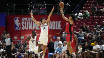 Jul 12, 2024; Las Vegas, NV, USA;  Washington Wizards guard Jules Bernard (14) attempts to block a shot by Atlanta Hawks forward Zaccharie Risacher (10) during the second half at Thomas & Mack Center. Mandatory Credit: Lucas Peltier-USA TODAY Sports